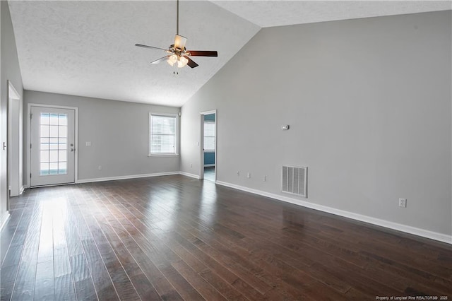 empty room with dark wood-type flooring, ceiling fan, high vaulted ceiling, and a textured ceiling