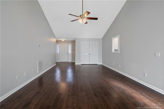 unfurnished living room with high vaulted ceiling, dark hardwood / wood-style floors, and ceiling fan