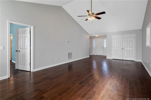 unfurnished living room featuring dark hardwood / wood-style flooring, high vaulted ceiling, and ceiling fan