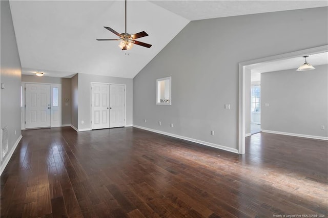 unfurnished living room with dark wood-type flooring, ceiling fan, and high vaulted ceiling