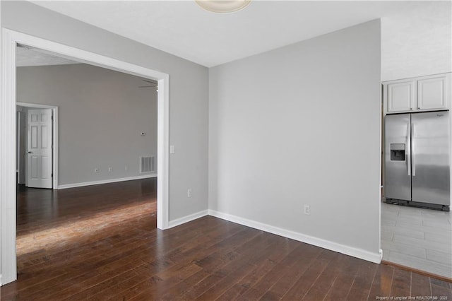 empty room with dark hardwood / wood-style floors