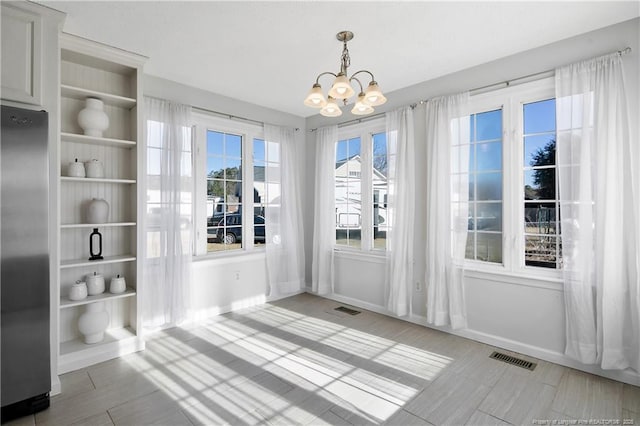 unfurnished dining area with a notable chandelier