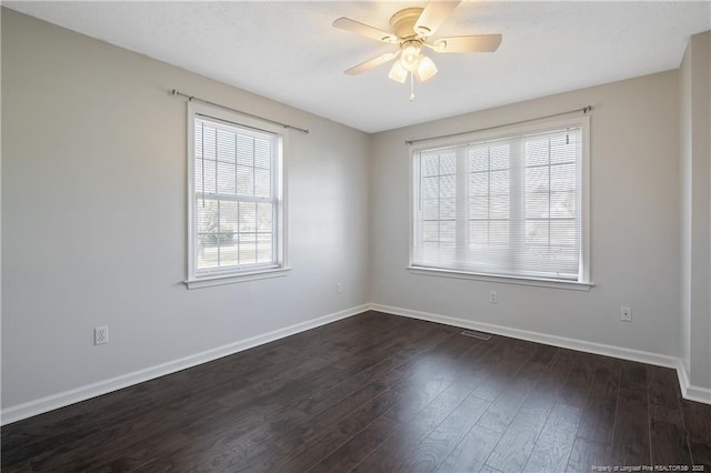 empty room featuring dark hardwood / wood-style floors and ceiling fan