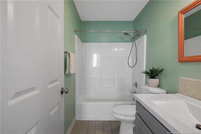 full bathroom with vanity, hardwood / wood-style floors, washtub / shower combination, and toilet