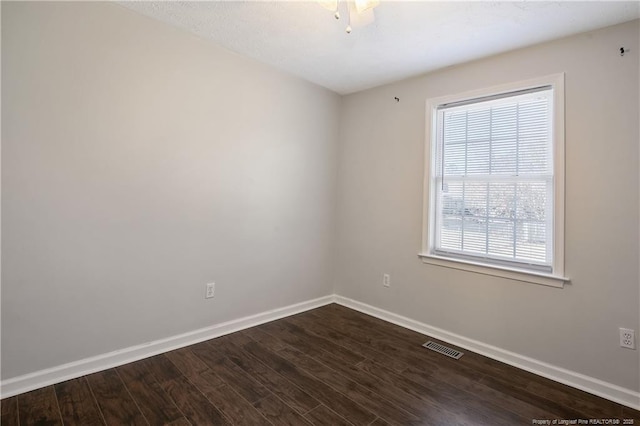 unfurnished room with dark wood-type flooring