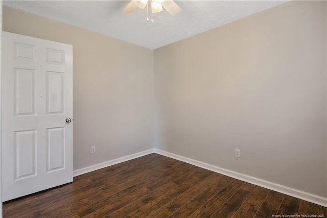 empty room with ceiling fan and dark hardwood / wood-style flooring