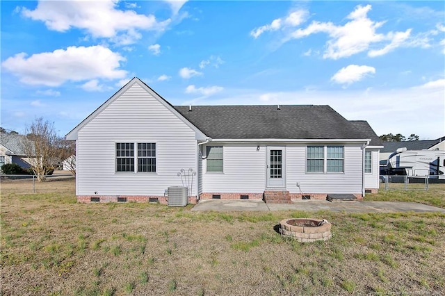 rear view of house featuring a patio area, a fire pit, and a lawn