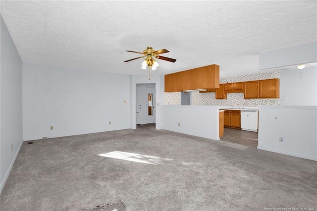 unfurnished living room featuring a textured ceiling, carpet floors, and ceiling fan