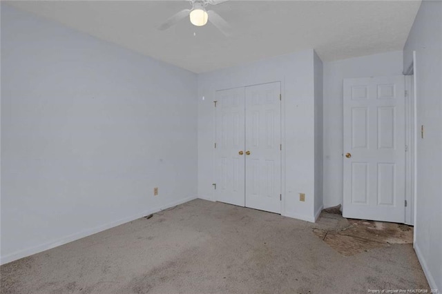 unfurnished bedroom with light colored carpet, a closet, and ceiling fan