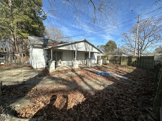 back of property with covered porch