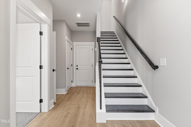 stairs featuring wood-type flooring