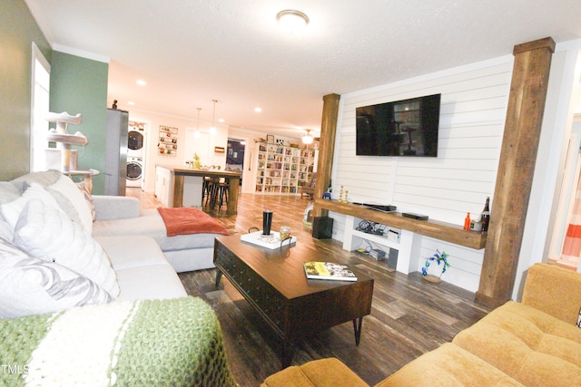 living room with recessed lighting, wood finished floors, washer / dryer, and crown molding