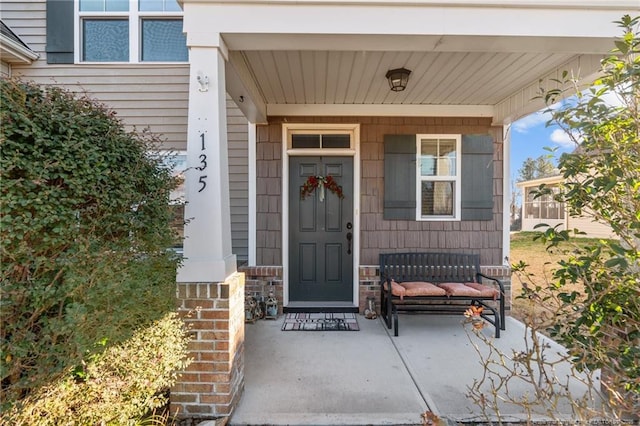 entrance to property featuring covered porch