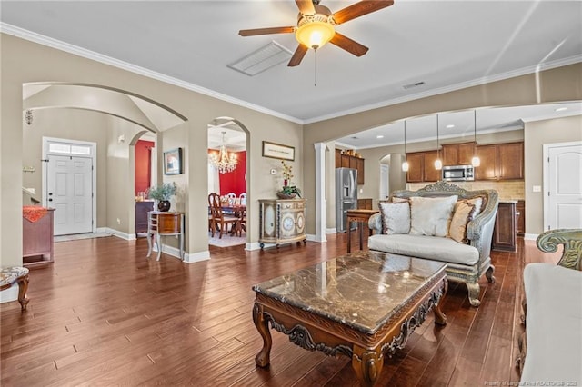 living room featuring crown molding, dark wood-type flooring, and ceiling fan