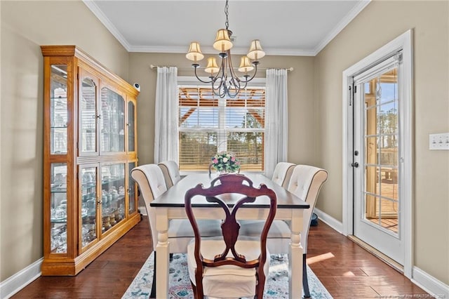 dining room featuring an inviting chandelier, a wealth of natural light, ornamental molding, and dark hardwood / wood-style floors