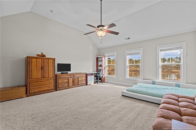 carpeted living room featuring ceiling fan, lofted ceiling, and a healthy amount of sunlight