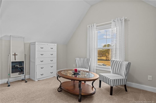 living area with vaulted ceiling and light colored carpet