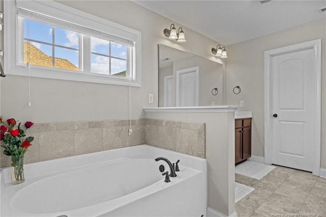 bathroom featuring vanity and a bathing tub