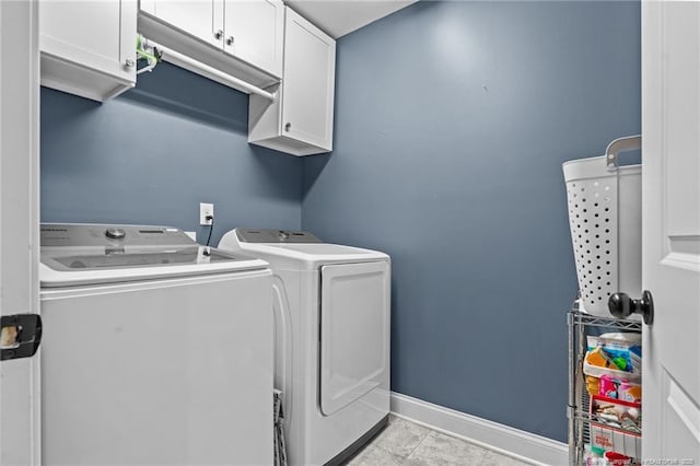 laundry room featuring cabinets and washing machine and clothes dryer