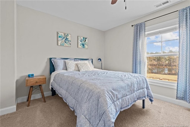 bedroom featuring ceiling fan and carpet