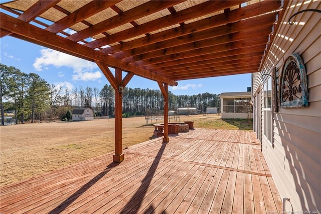 wooden deck with a pergola and a lawn