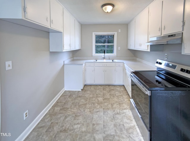 kitchen featuring stainless steel range with electric stovetop, sink, and white cabinets