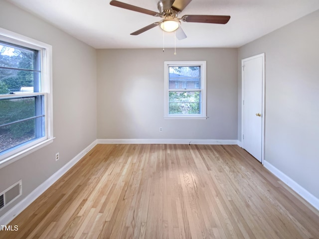 spare room with ceiling fan and light wood-type flooring