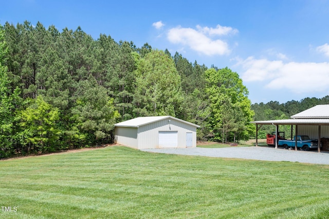 view of yard featuring a garage, an outdoor structure, and a carport