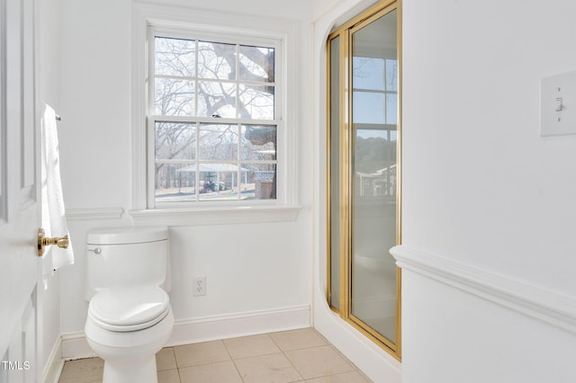 bathroom featuring an enclosed shower, tile patterned floors, and toilet