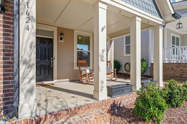 view of exterior entry featuring a porch