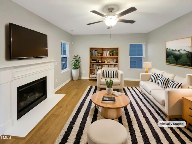 living room with ceiling fan and light wood-type flooring