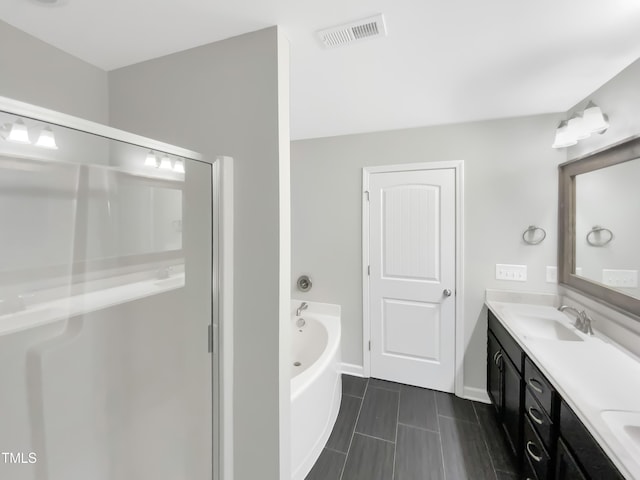 bathroom with vanity and independent shower and bath