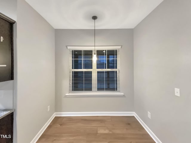 unfurnished dining area featuring hardwood / wood-style floors