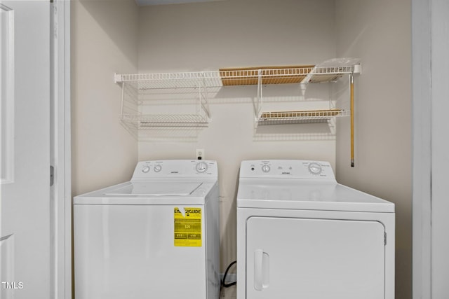 clothes washing area with washer and clothes dryer