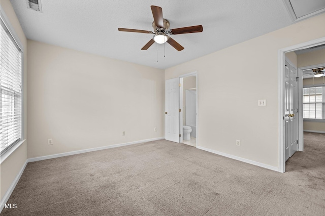 carpeted spare room with ceiling fan