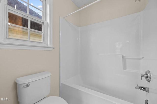 bathroom with shower / tub combination and toilet