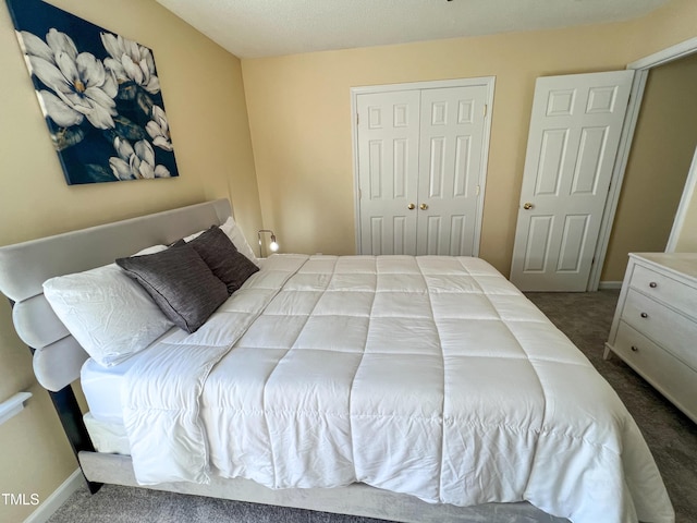 carpeted bedroom featuring a closet and baseboards