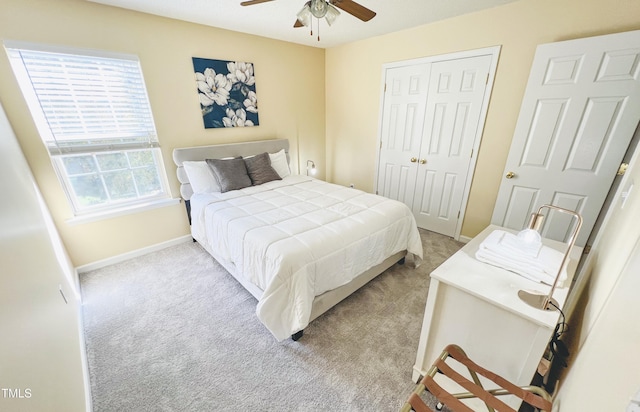 bedroom featuring ceiling fan, a closet, carpet flooring, and baseboards