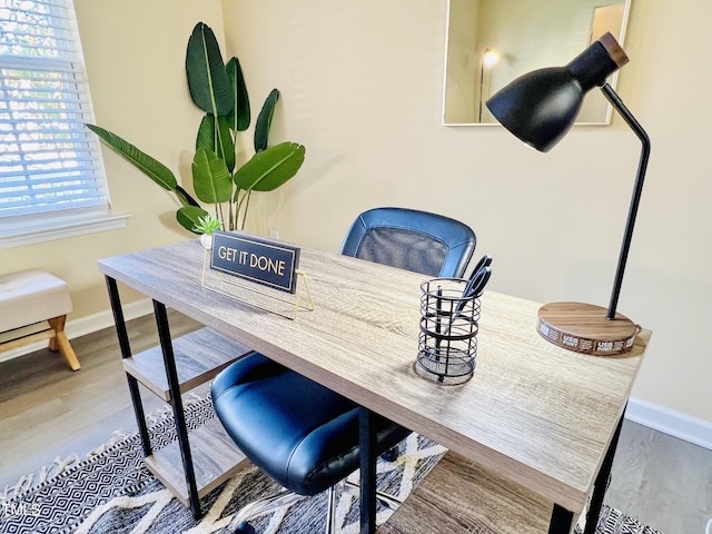 interior space featuring wood finished floors and baseboards