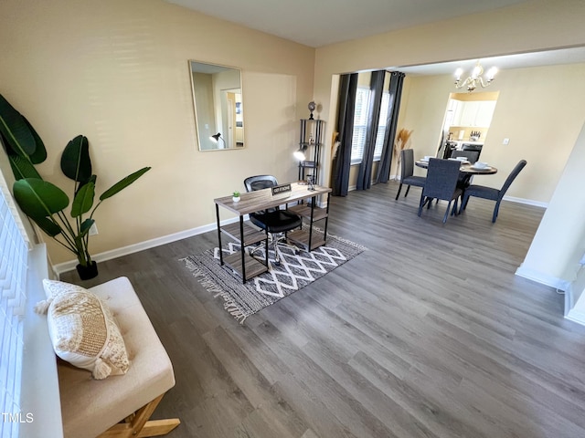 home office with an inviting chandelier, wood finished floors, and baseboards