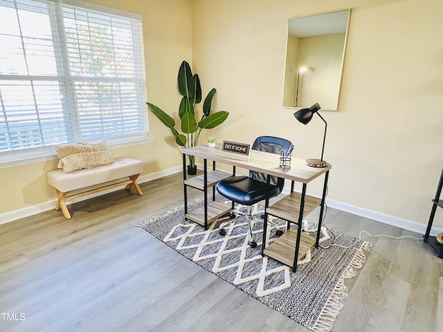 home office with wood finished floors and baseboards