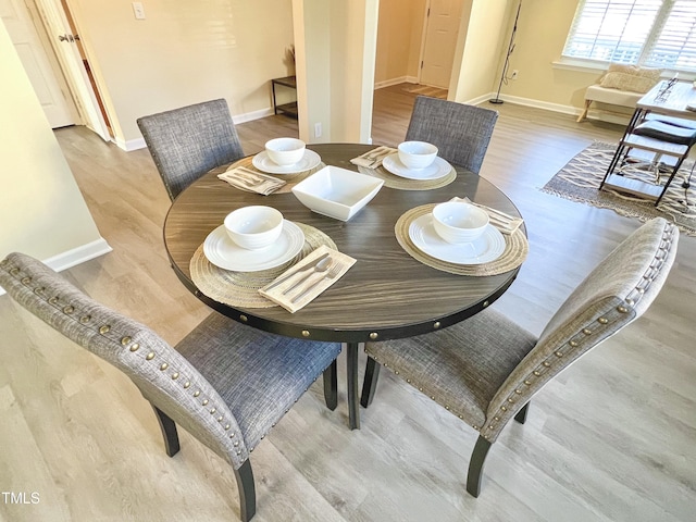 dining area with wood-type flooring