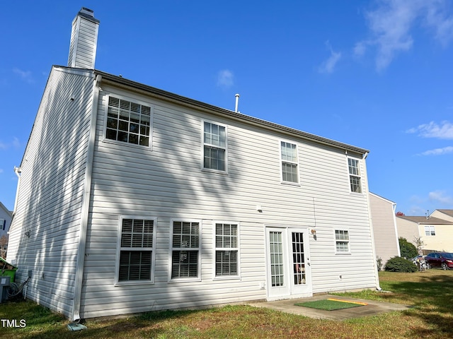 rear view of house with a lawn