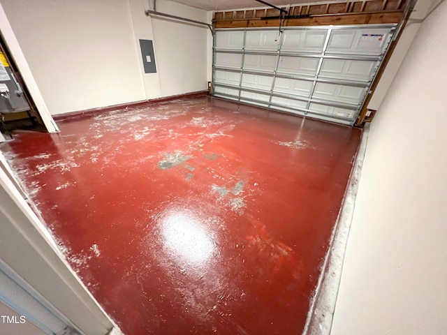 garage with electric panel and baseboards