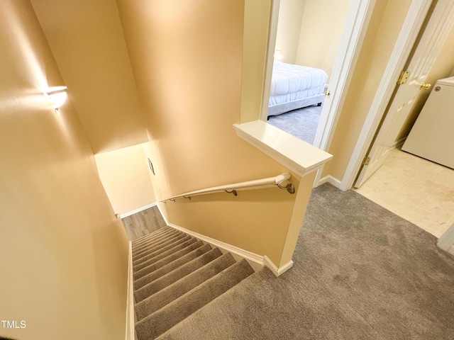 stairs featuring carpet and baseboards