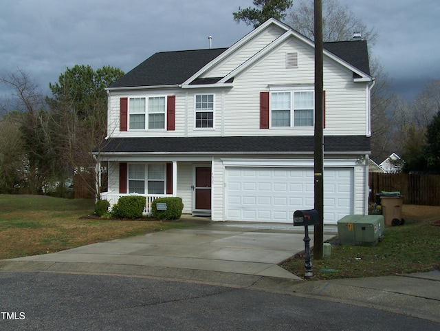 traditional-style house with a porch, an attached garage, concrete driveway, roof with shingles, and a front yard