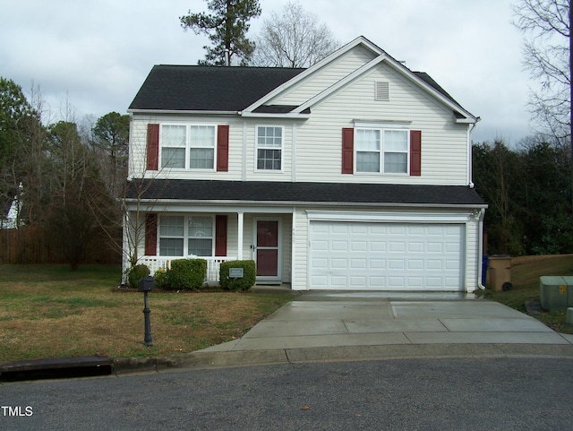 traditional-style home featuring a front yard, covered porch, driveway, and an attached garage