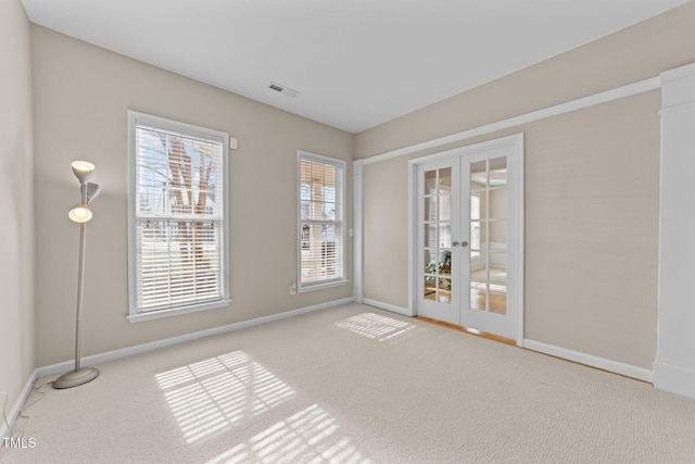 empty room featuring french doors and carpet floors