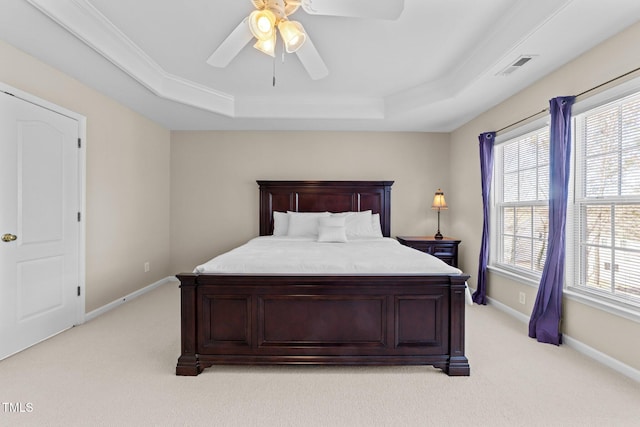 bedroom featuring light carpet, a raised ceiling, and ceiling fan