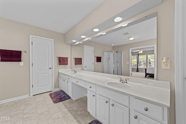 bathroom featuring vanity and a shower with door